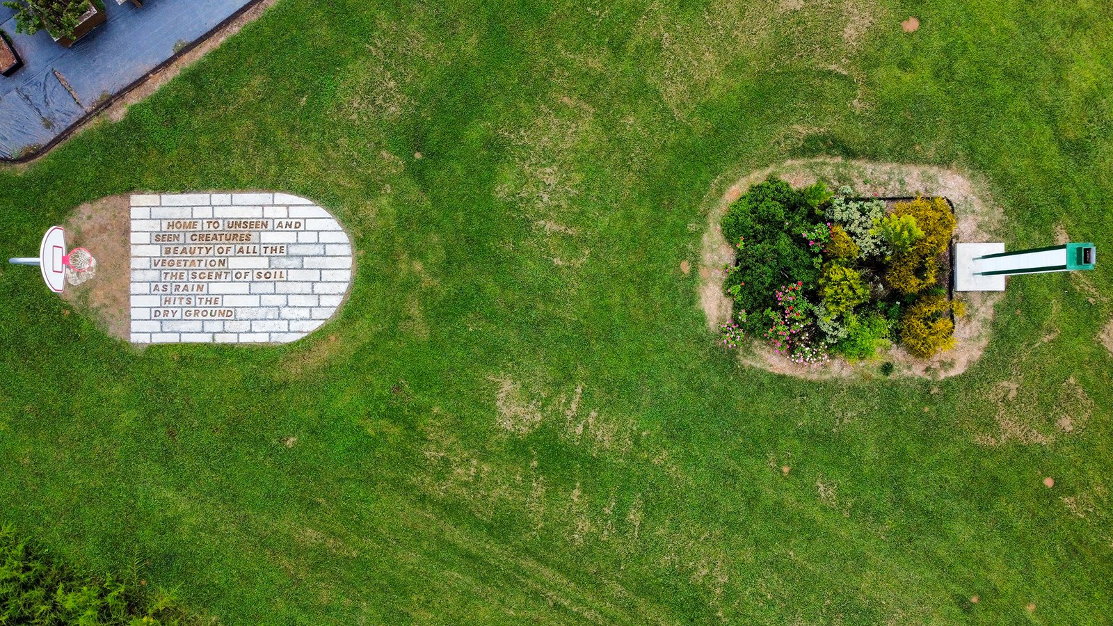 An aerial photo of folks playing on the experimental concrete basketball key, the garden key and the swift tower